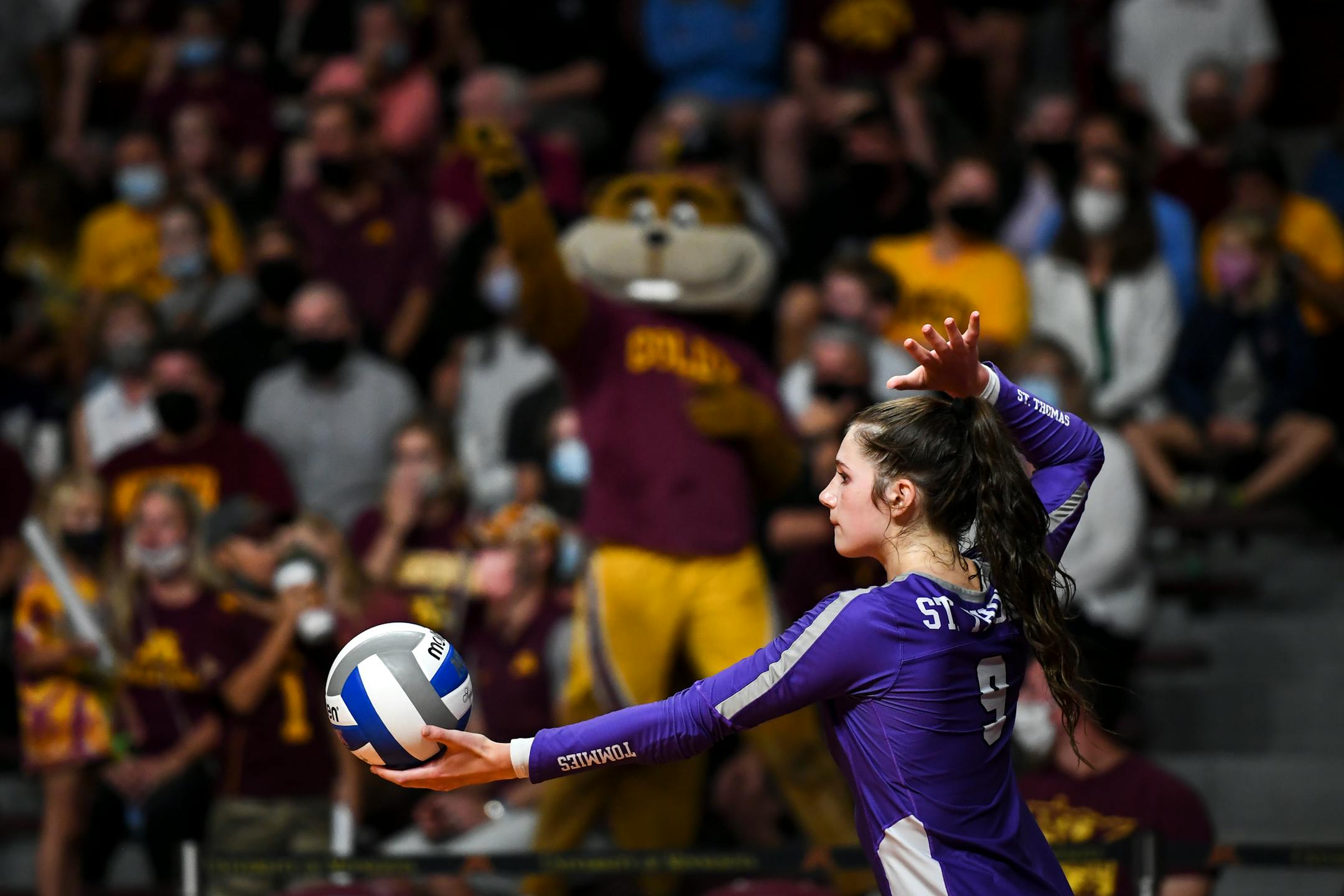 St. Thomas outside hitter Lauren Galvin (9) prepared to serve in the third set against the University of Minnesota Gophers.