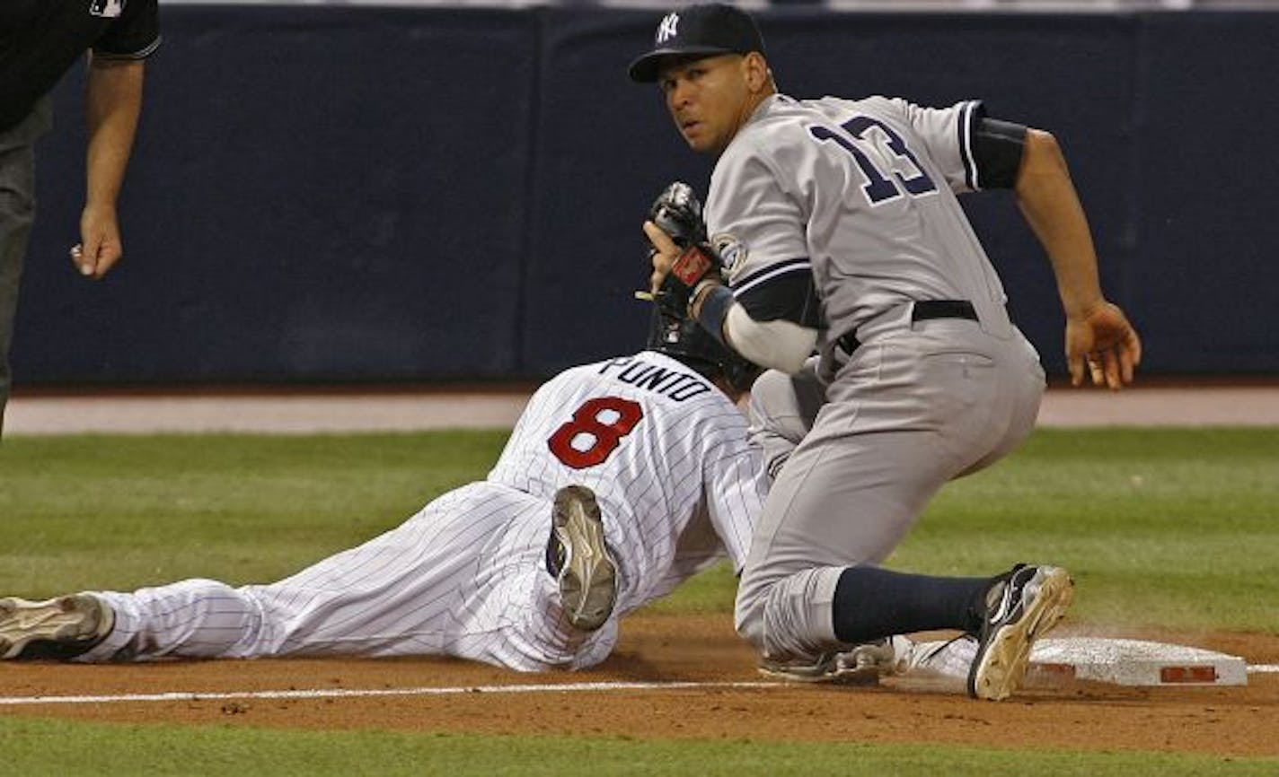 Twins second baseman Nick Punto was tagged out at third by Yankees third baseman Alex Rodriguez after Punto overran the base in the eighth inning during Game 3 of the 2009 ALDS.