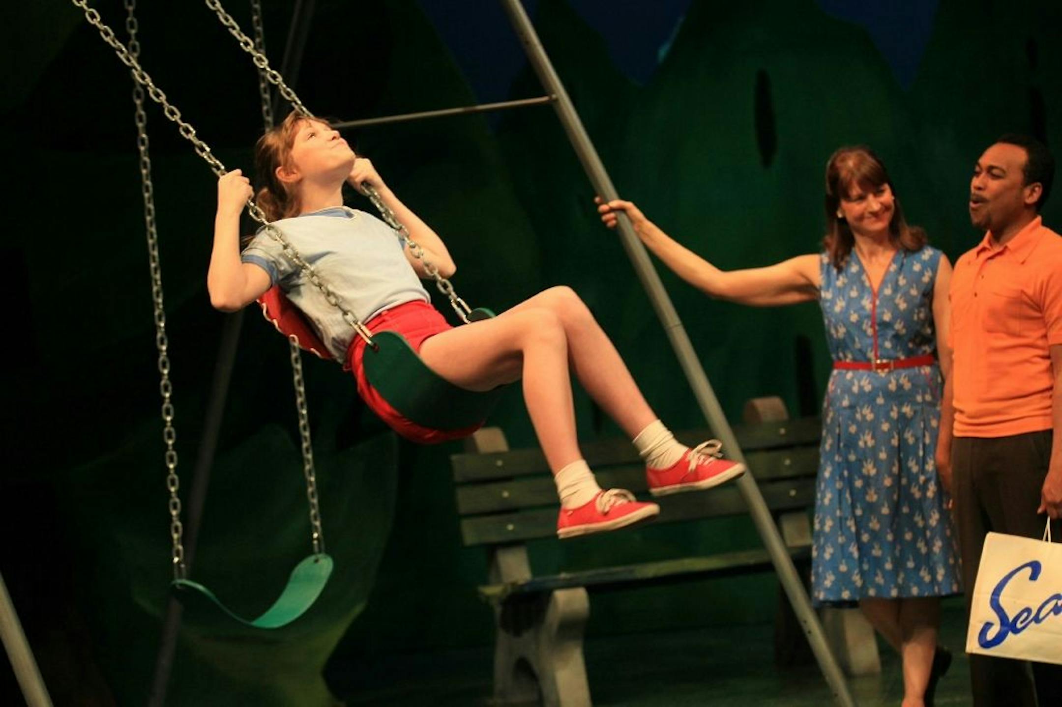 Megan Fischer, on the swing, plays young Mary Ellen Collins-Richardson in "American Family" at Park Square Theatre. Noël Raymond and Gavin Lawrence portray her mother and stepfather in the new drama by Carlyle Brown.