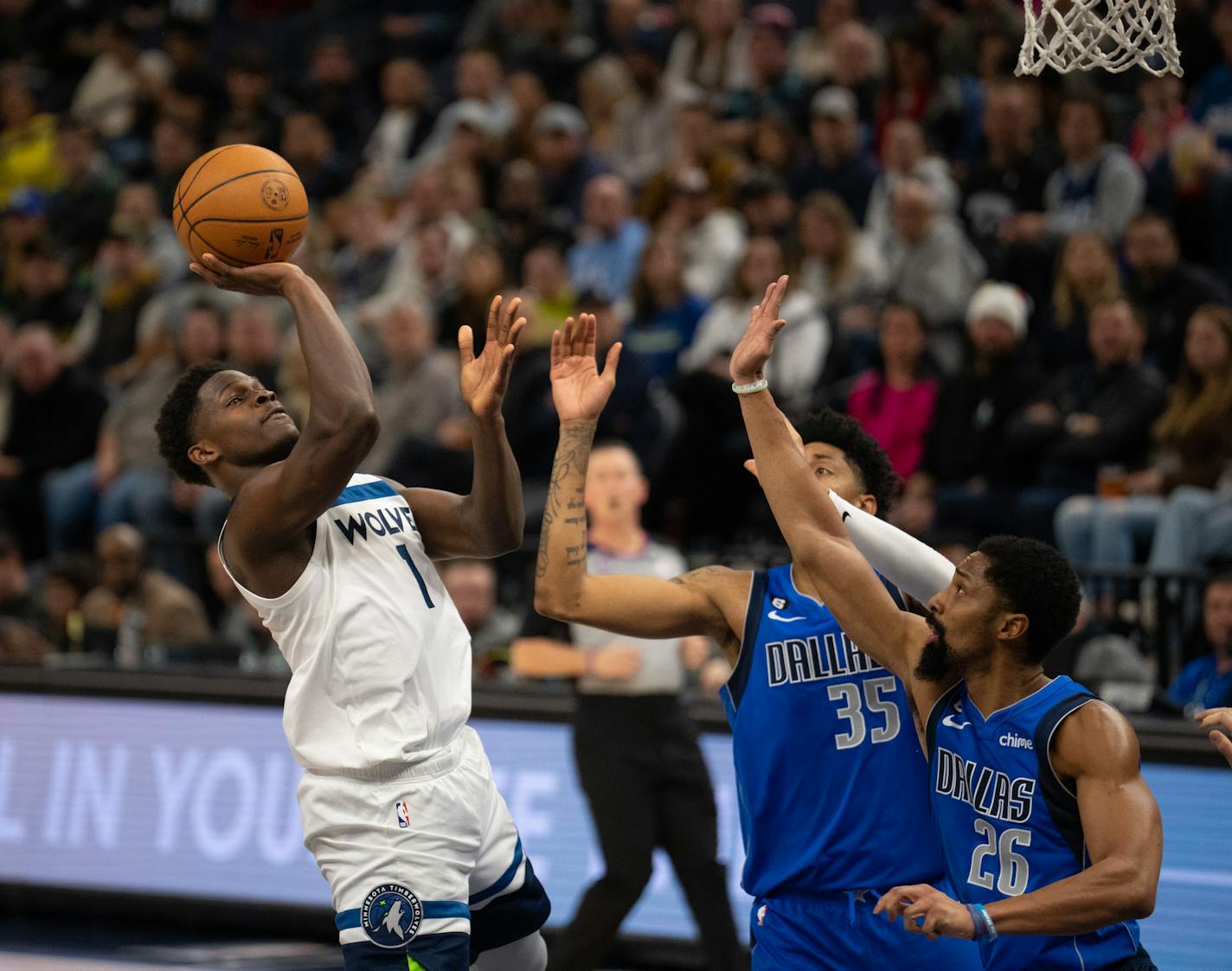 Minnesota Timberwolves guard Anthony Edwards (1) shot over the defense of Dallas Mavericks forward Christian Wood (35) and Mavericks guard Spencer Dinwiddie (26) in the second quarter Monday night, December 19, 2022. The Minnesota Timberwolves faced the Dallas Mavericks in an NBA basketball game at Target Center in Minneapolis. ] JEFF WHEELER • jeff.wheeler@startribune.com