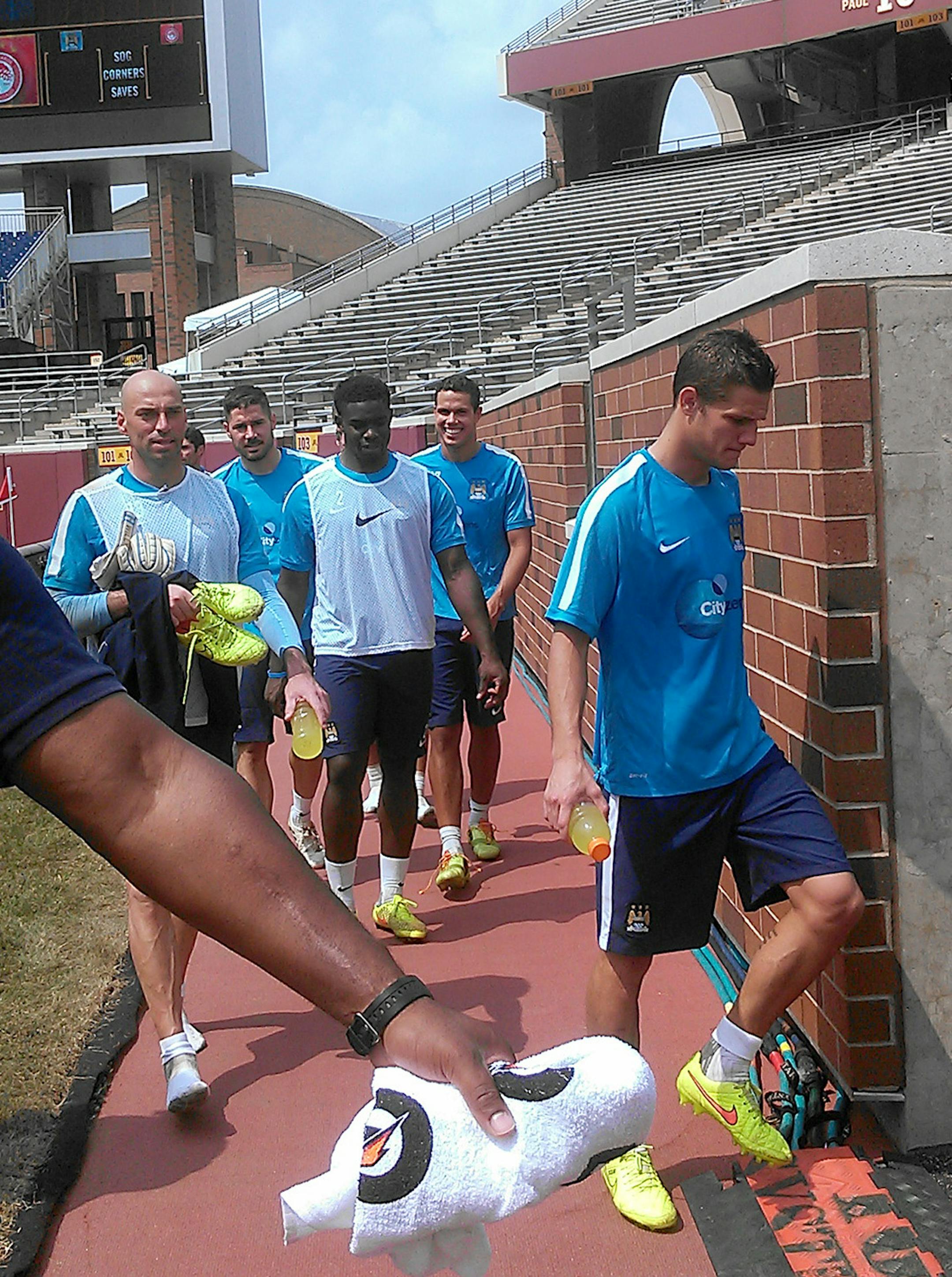 Players from Manchester City left the pitch at TCF Bank Stadium after a Friday practice. The team manager said the temporary grass field is substandard and an injury risk.