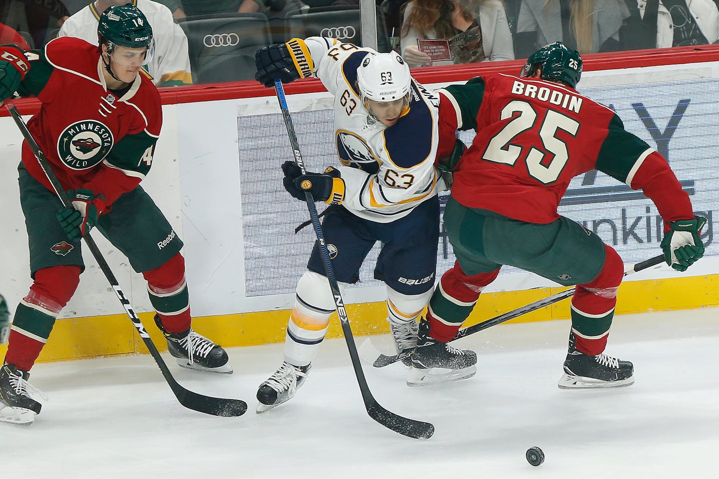 Buffalo Sabres' Tyler Ennis tries to gain control of the puck against Minnesota Wild's Joel Eriksson Ek, left, and Jonas Brodin, right, in the first period of an NHL hockey game Tuesday, Nov. 1, 2016, in St. Paul, Minn. (AP Photo/Stacy Bengs)