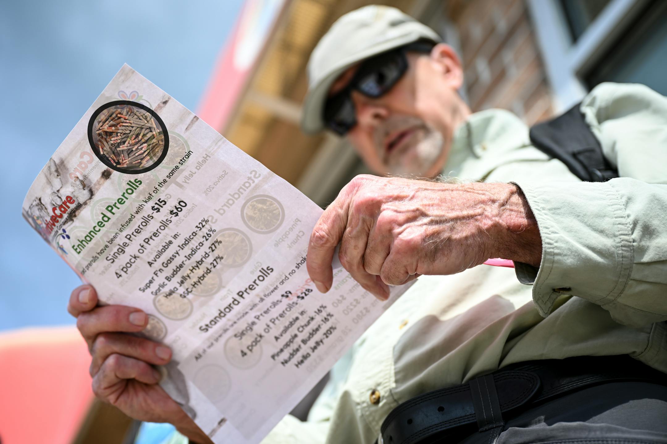 John Webster, of Eastern North Dakota, looks at the cannabis menu before the dispensary's opening Tuesday, Aug. 1, 2023 at NativeCare in Red Lake, Minn.