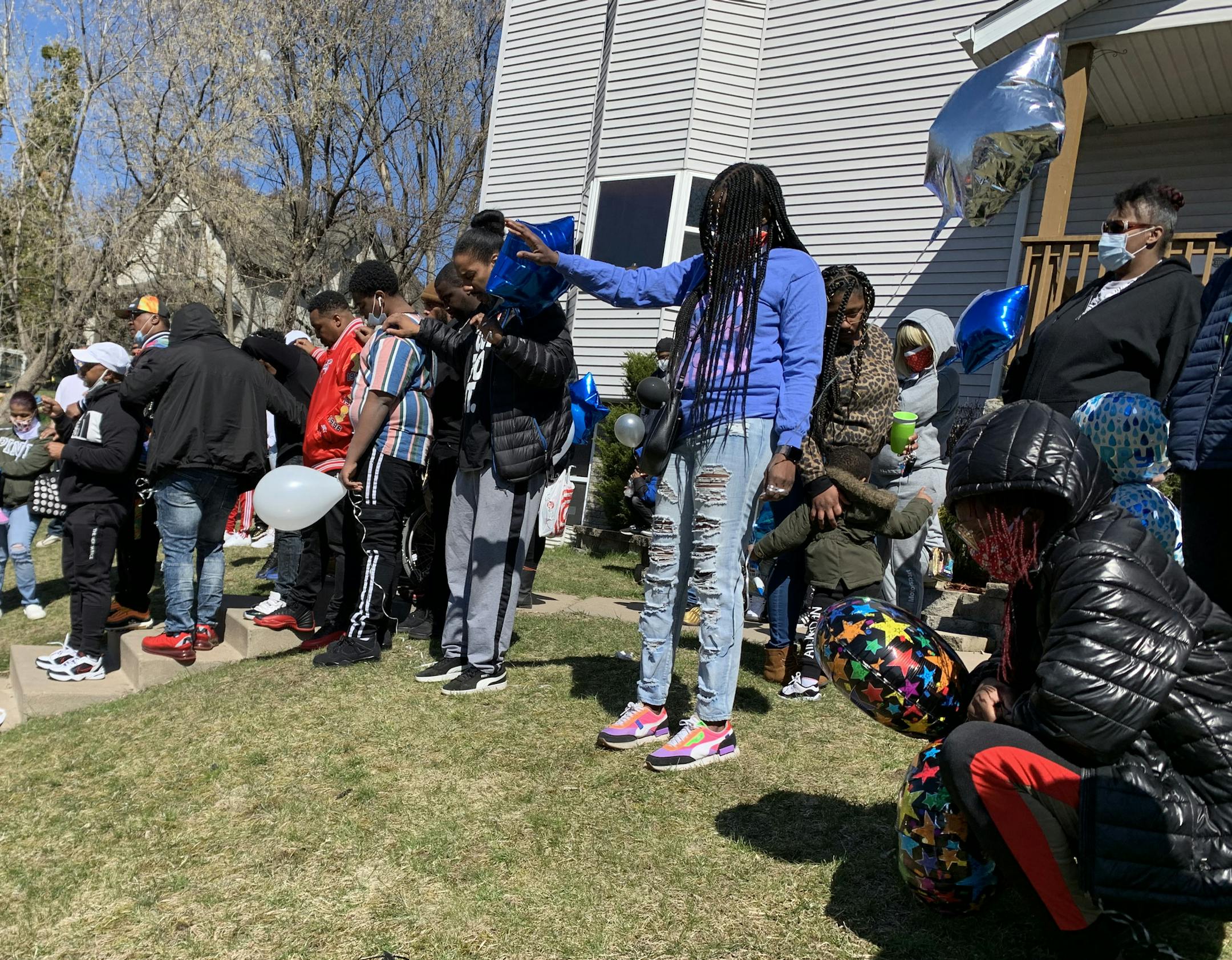 People mourn the loss of shooting victim Kevin Beasley in Minneapolis on Sunday, April 19, 2020. Beasley was the man shot to death at a house party in Minneapolis' Near North neighborhood, according to family, and was the grandson of veteran peace and civil rights activist Spike Moss. (Libor Jany/Star Tribune) ORG XMIT: MIN2004191717567165