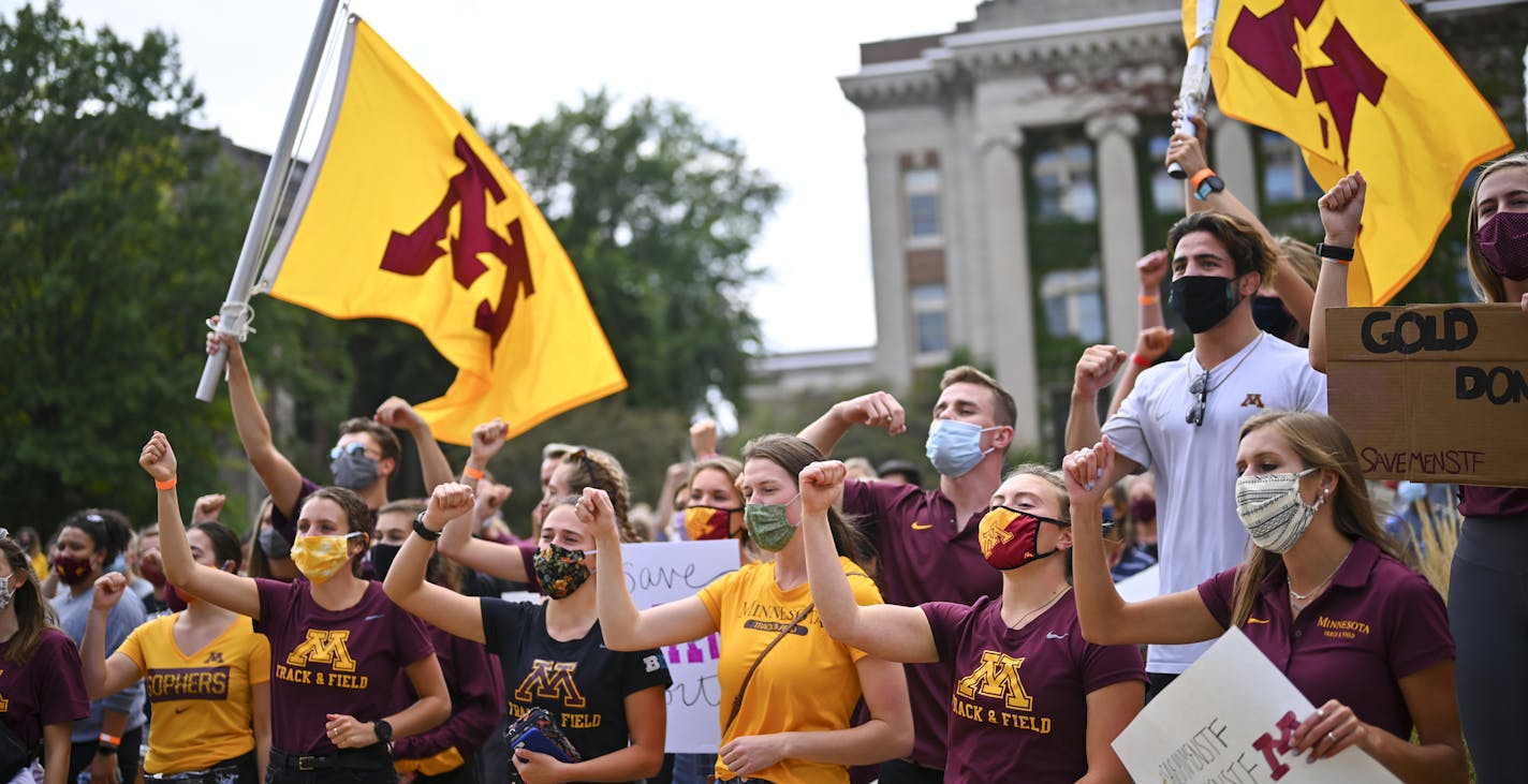 Gophers student athletes sang the Minnesota Rouser after concluding a march and protest against plans by the university to cut four men's sports Wednesday. . ] aaron.lavinsky@startribune.com Gophers student athletes marched from the Athletes Village to Morrill Hall to demonstrate against recently announced plans to cut men's track and field, tennis and gymnastics. The march was held Wednesday, Sept. 16, 2020 at the University of Minnesota in Minneapolis, Minn.