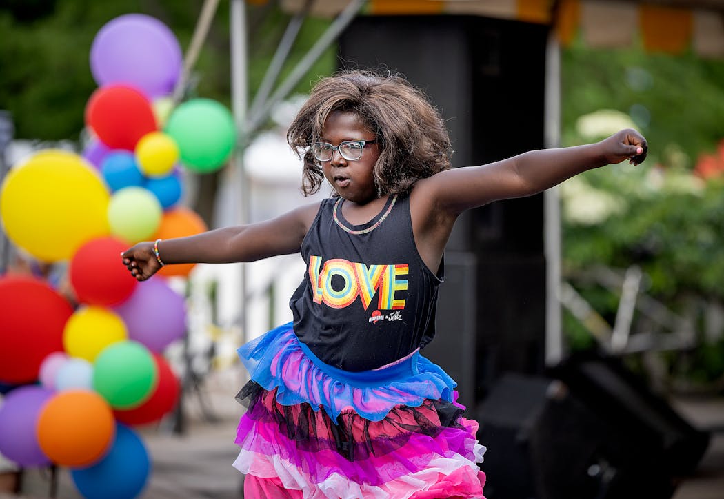 Clara Rose, 11, takes the stage to dance at Twin Cities Pride Youth Night in Loring Park in Minneapolis on Friday. Her mother Faith Rose, of Faribault, said Clara Rose used to get picked on a lot on the school bus and kids would knock off her wigs.