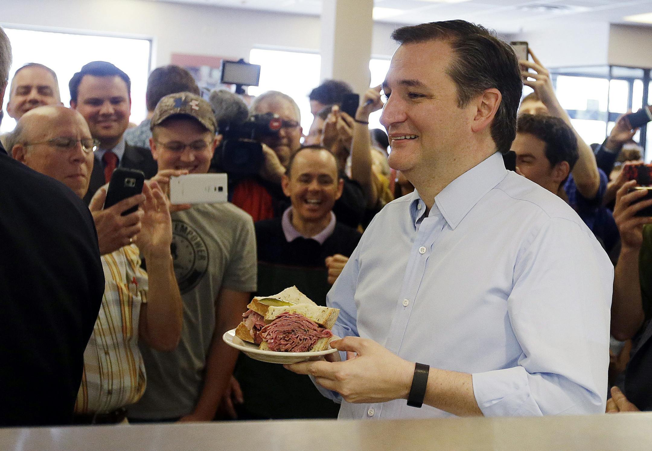 Republican presidential candidate, Sen. Ted Cruz, R-Texas holds his sandwich during a campaign stop at Shapiro's Delicatessen, Thursday, April 21, 2016, in Indianapolis. (AP Photo/Darron Cummings)