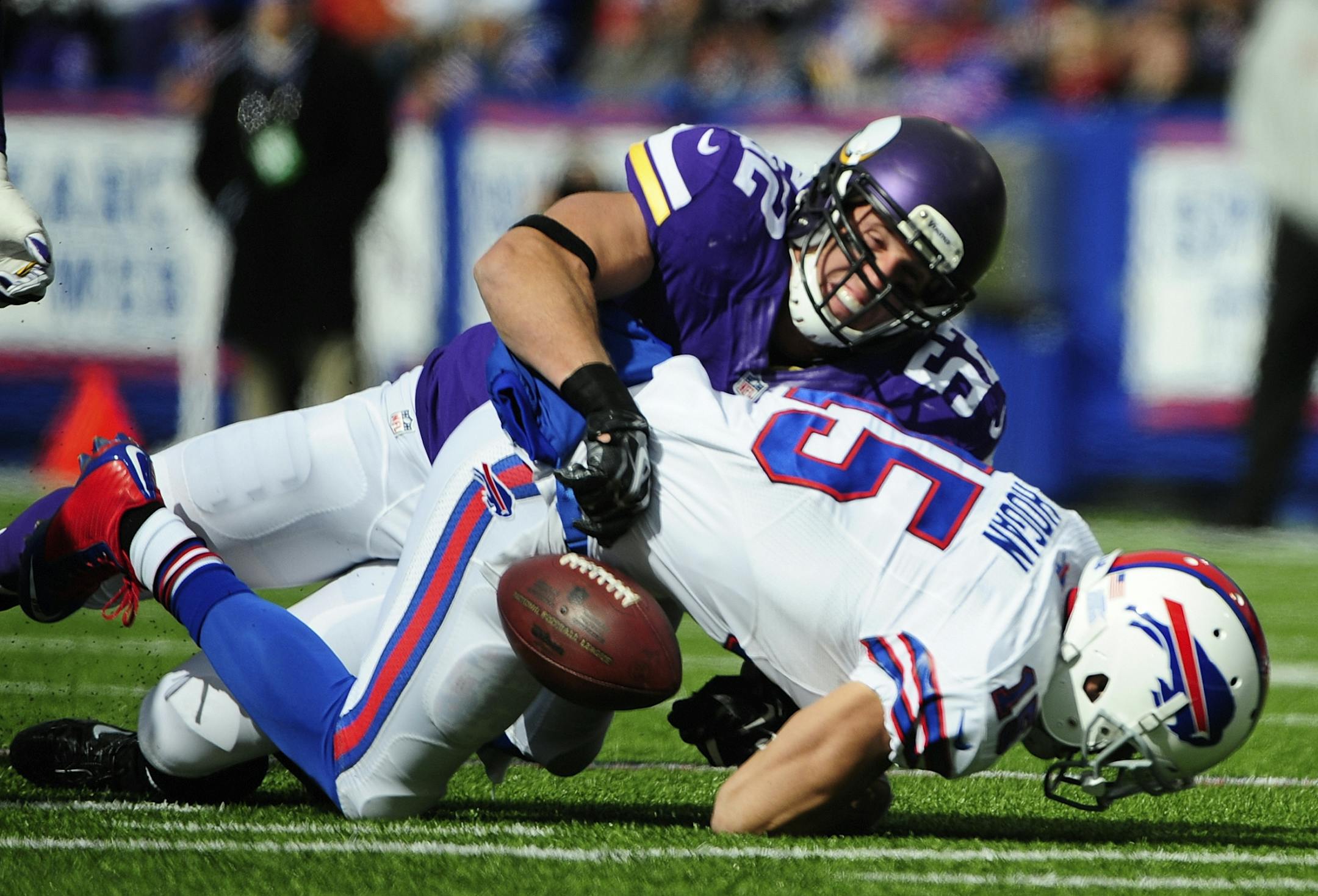 Buffalo Bills wide receiver Chris Hogan (15) fumbles the ball as he is tackled by Minnesota Vikings' Chad Greenway (52) during the first half of an NFL football game Sunday, Oct. 19, 2014, in Orchard Park, N.Y.