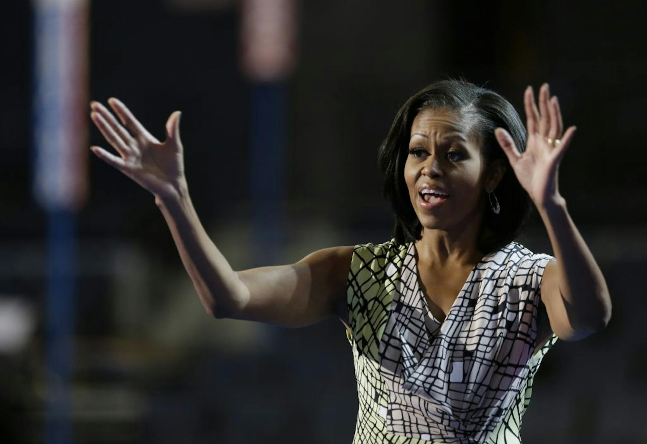First Lady Michelle Obama waved as she appeared at the podium Monday for a camera test on the stage at the Democratic National Convention inside Time Warner Cable Arena in Charlotte, N.C.