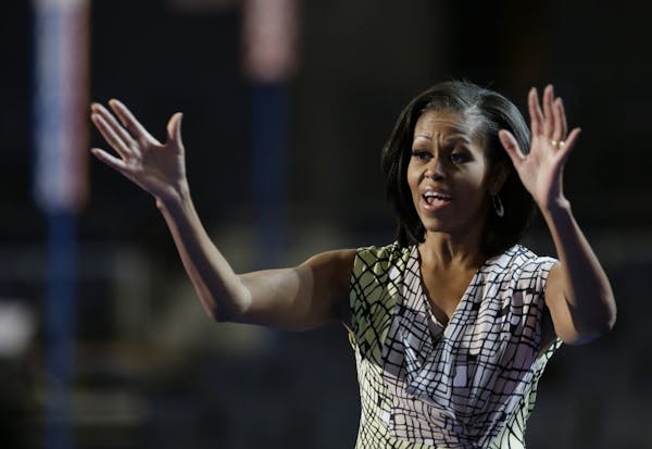 First Lady Michelle Obama waved as she appeared at the podium Monday for a camera test on the stage at the Democratic National Convention inside Time 