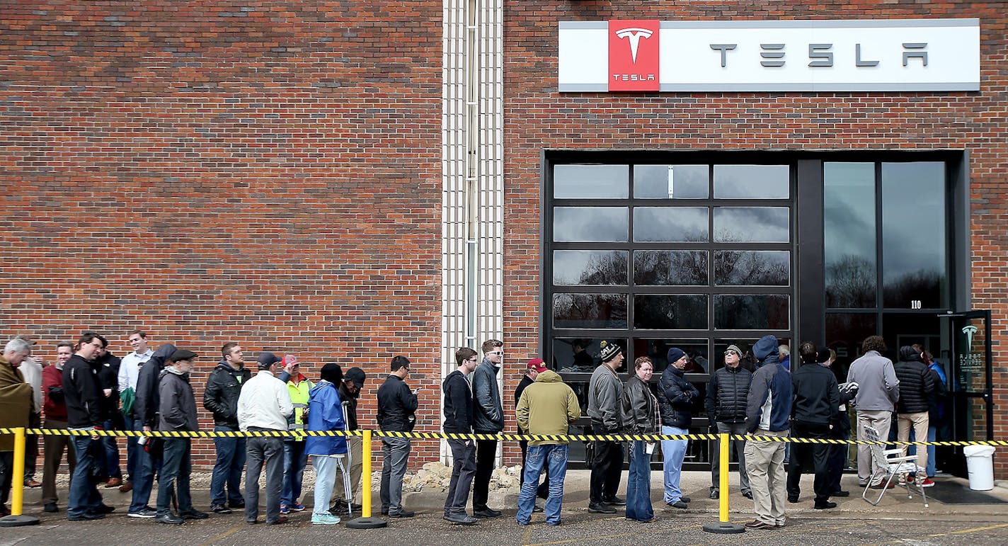 Car enthusiasts lined up outside Tesla in Eden Prairie, MN, Thursday March 31, 2016. They did this to get on a waiting list for the new Model 3 electric car. With a starting price of $35,000 before government incentives, the Model 3 is less than half the cost of Tesla's previous models. The car will be revealed Thursday night at its Los Angeles design studio. ] (ELIZABETH FLORES/STAR TRIBUNE) ELIZABETH FLORES &#x2022; eflores@startribune.com