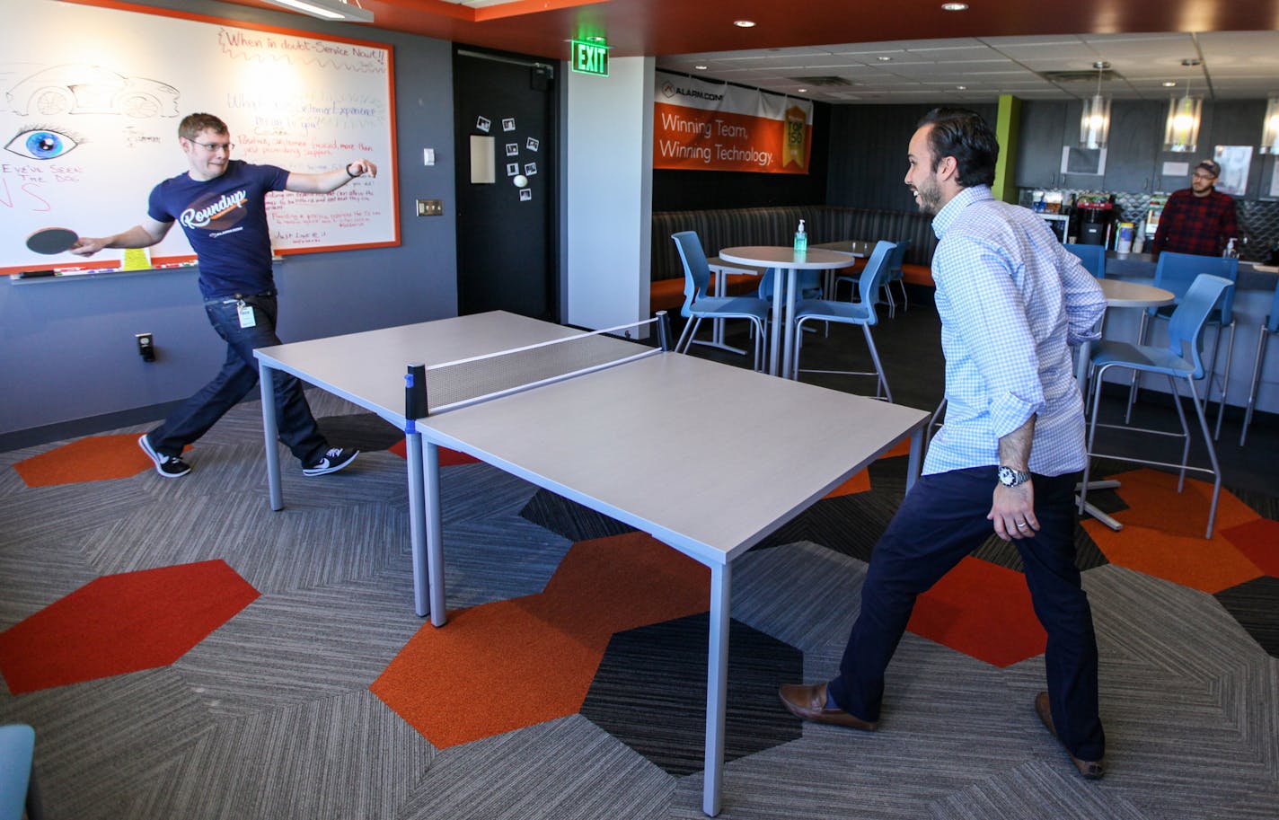 Charlie Frederickson and Javier Castanedar, both the employees of the company, were playing ping pong at the resting area on 22nd floor. ] XAVIER WANG &#x2022; xavier.wang@startribune.com Employees in the company ALARM.COM use and live in the office space in a creative and fun way, which makes the office doesn't resemble the traditional call center. The photos were taken on Thursday June 1, 2017 in Bloomington.