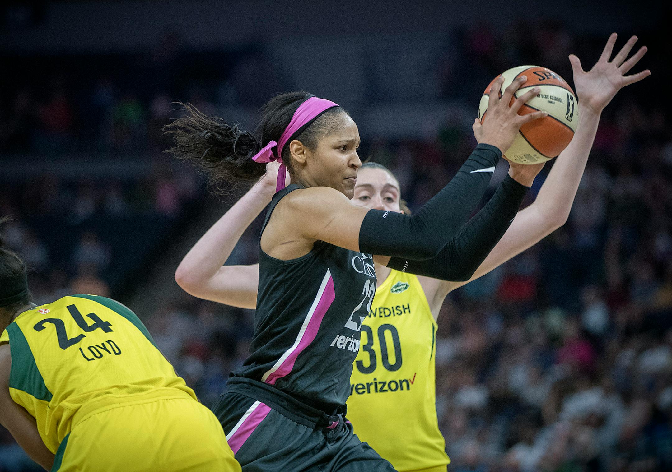 Minnesota Lynx forward Maya Moore drove passed Seattle Storm's guard Jewell Loyd, left, and forward Breanna Stewart during the third period as the Minnesota Lynx took on the Seattle Storm, at Target Center, Sunday, August 12, 2018 in Minneapolis, MN. ] ELIZABETH FLORES ï liz.flores@startribune.com