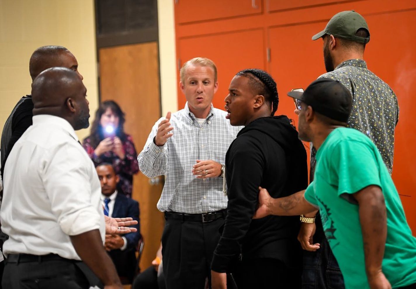 The BCA's Drew Evans, back center, was unable to speak Thursday night as angry protesters and members of the Blevins family got into a heated verbal confrontation with organizers and Evans.