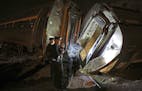 FILE - In this May 12, 2015 file photo, emergency personnel work the scene of a train wreck An Amtrak train headed to New York City derailed and crash