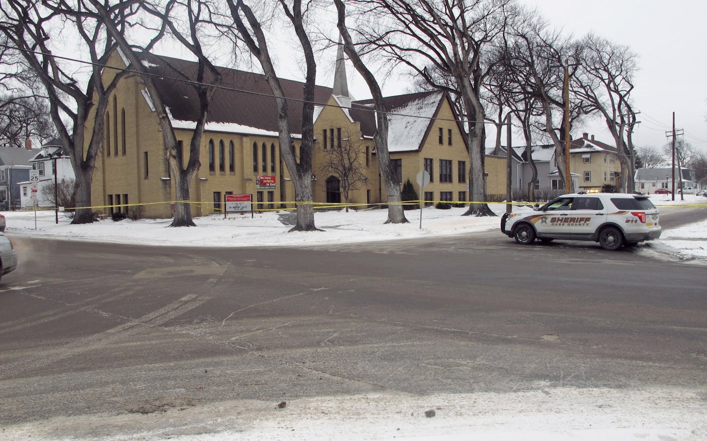 Authorities block off an area in front of Plymouth Congregational Church and near a house in north Fargo, N.D., Thursday, Feb. 11, 2016, where a suspect fired at police officers during an 11-hour standoff that left a Fargo police officer near death. Police chief Dave Todd says that Officer Jason Moszer will not survive his wounds. The suspect, who has not been identified was found dead from a shotgun wound.