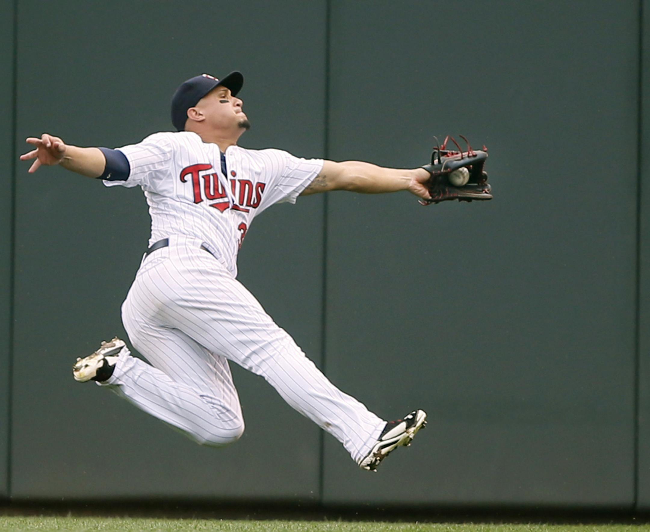 Minnesota Twins right fielder Oswaldo Arcia (31) made a diving catch to get Kansas City Royals second baseman Omar Infante (14) out in the sixth inning at Target Field Sunday August 17 , 2014 in Minneapolis MN .The Twins lost 12-6. ] Jerry Holt Jerry.holt@startribune.com