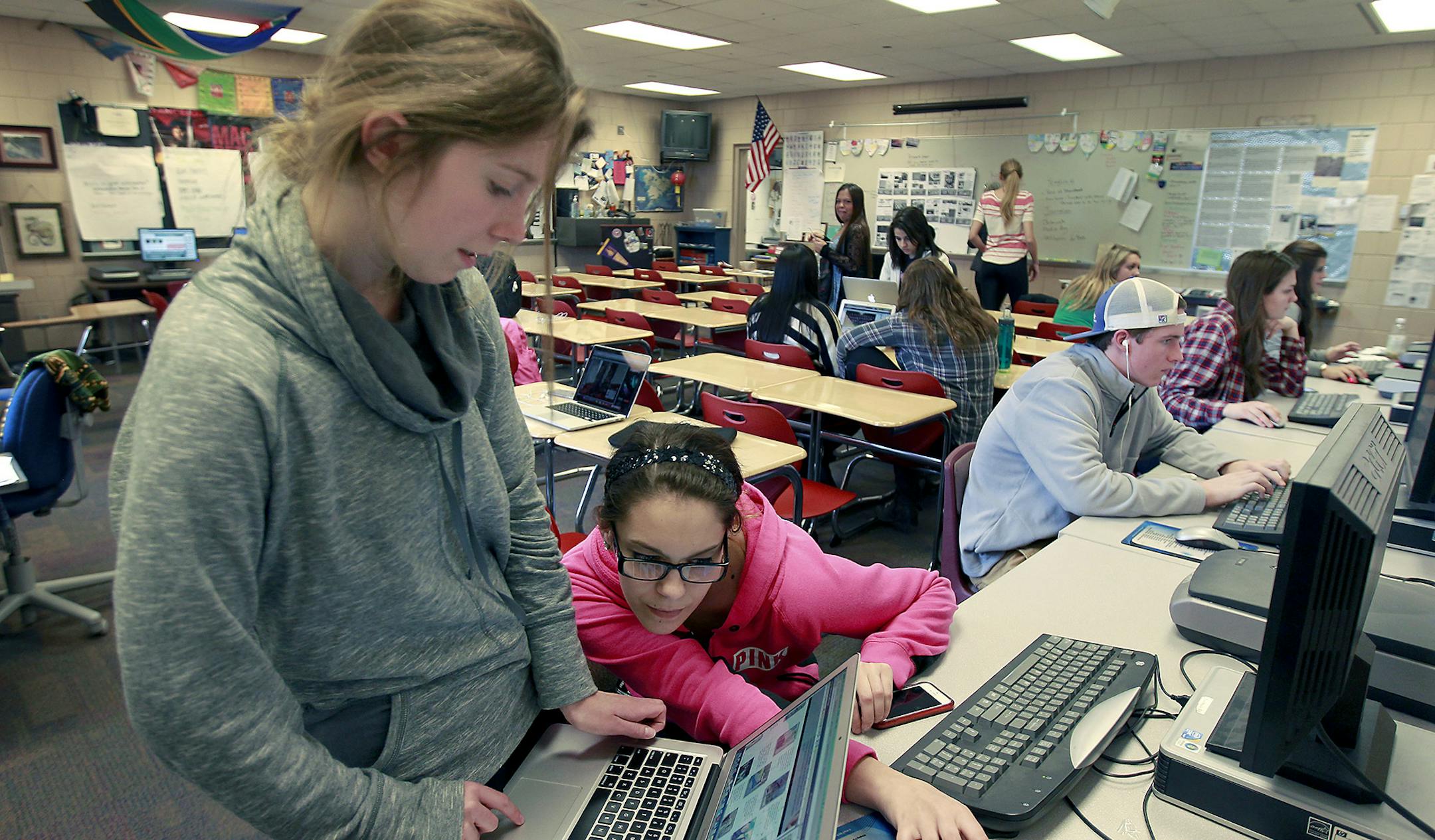 Stillwater High School students Ava Leintz, left, and Jordan Brandt put the pages of their yearbook together, Friday, April 10, 2015 in Stillwater, MN. ] (ELIZABETH FLORES/STAR TRIBUNE) ELIZABETH FLORES • eflores@startribune.com
