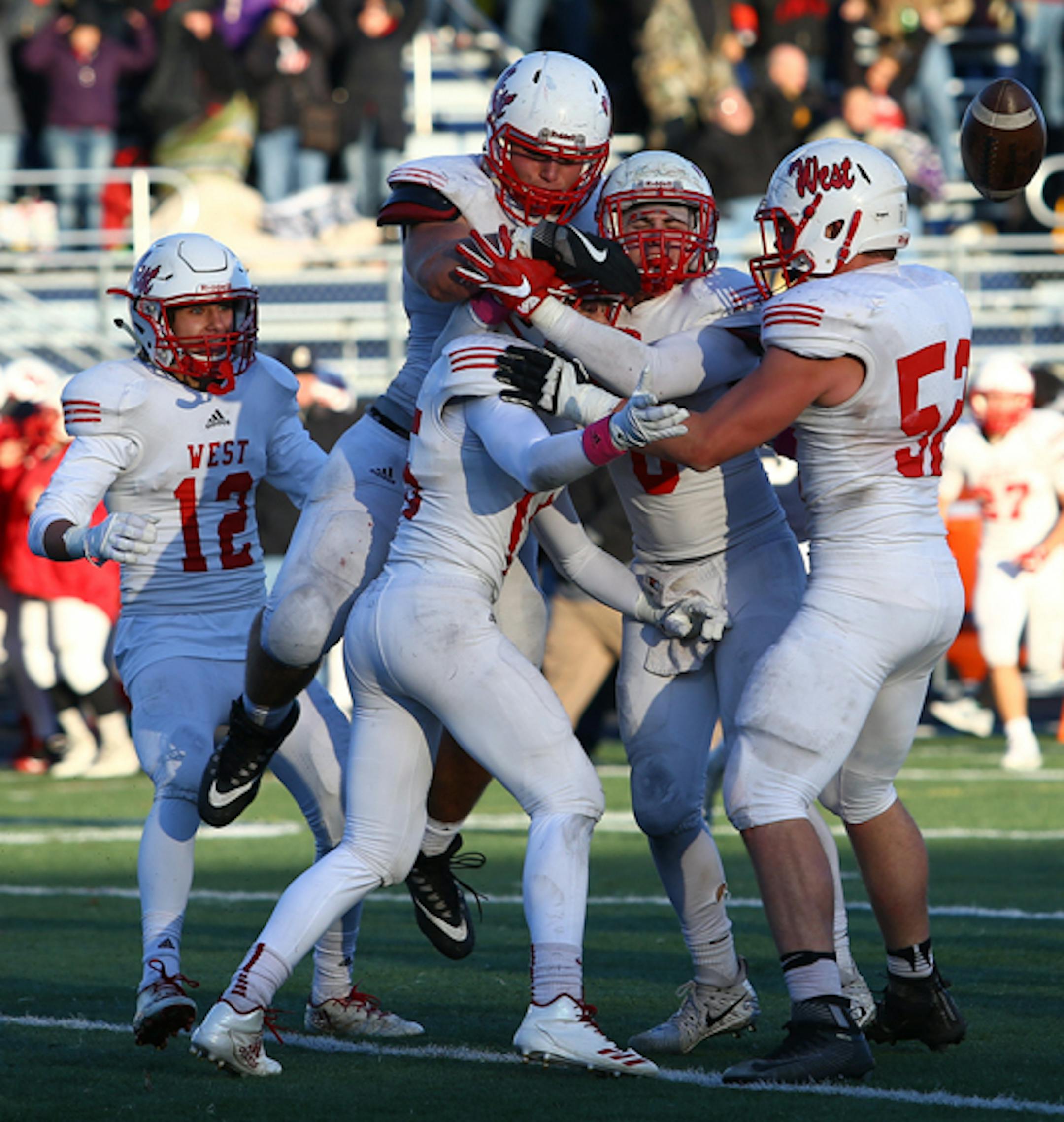 Mankato West celebrates Josh Block's interception late in the game securing a 14-7 victory over Chanhassen in the Class 5A, Section 2 semifinal matchup. The number three seed Scarlets will host the number four seed from Waconia on Friday night. Photo by Cheryl Myers, SportsEngine