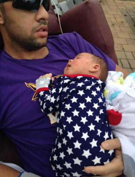 Isaac Kolstad holds infant daughter, Malia, in a photo posted on his CaringBridge web page.