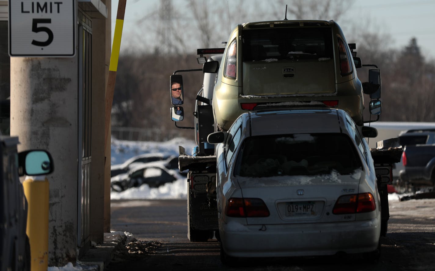 Tow truck drivers bring cars to the city impound lot Tuesday. ] ANTHONY SOUFFLE &#x2022; anthony.souffle@startribune.com Car owners retrieve their vehicles that were towed during the weekend's snow emergency Tuesday, Dec. 13, 2016 at the city impound lot in Minneapolis.