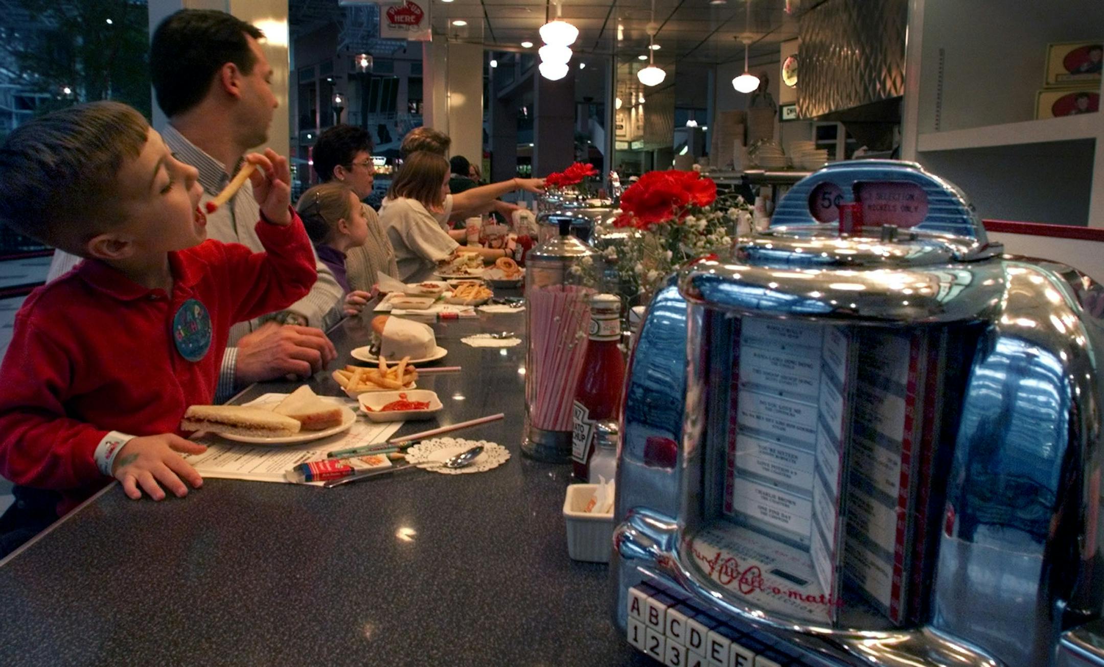 Andrew Meyers 4 left and his father Ken Meyers enjoy the food at Johnny Rockets dinner at the Mall of America.
