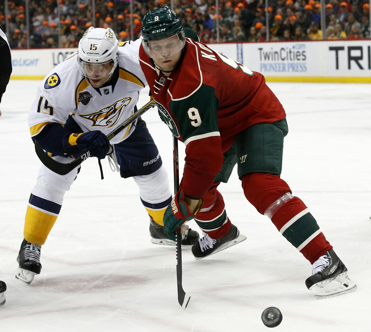 Minnesota Wild center Mikko Koivu (9) wins a face-off against Nashville Predators center Craig Smith (15) during the second period of an NHL hockey game in St. Paul, Minn., Thursday, Nov. 5, 2015. (AP Photo/Ann Heisenfelt)