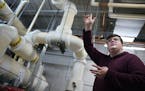 Former student project manager and current mentor Griffen Peck shows the heating pipes that take advantage of the excess steam from the Minneosta Zoo,