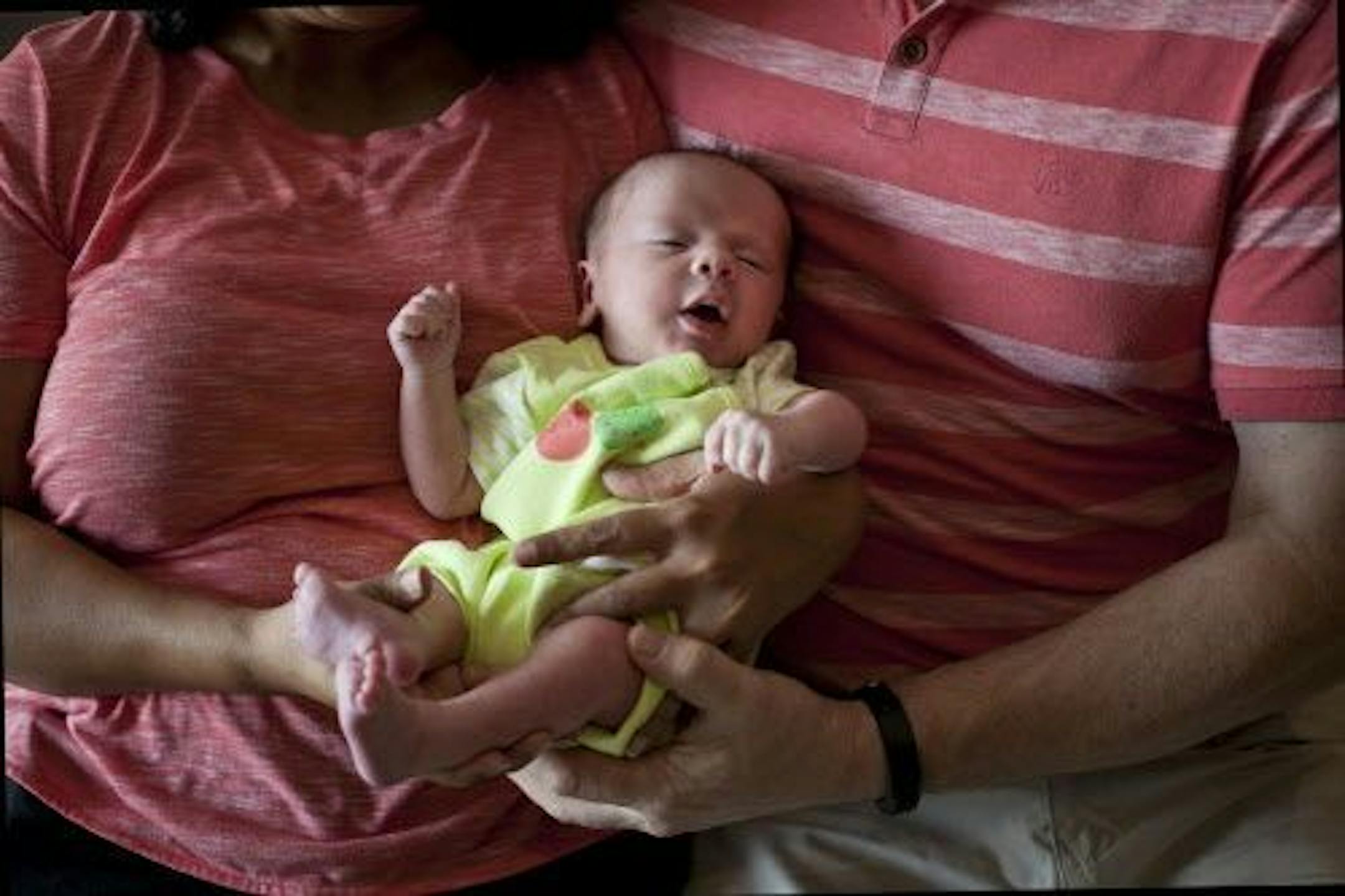 In this Nov. 5, 2015 photo, a couple from Britain hold their baby, born on Oct. 17 by a surrogate, in Anand, India. The couple came to Akanksha Clinic, one of the most organized clinics in the surrogacy business in India, after being unable to bear a child for 15 years. The low-cost technology, skilled doctors, scant bureaucratic controls and a plentiful supply of surrogates have made India a preferred destination for fertility tourism, attracting couples from Britain, the United States, Austral