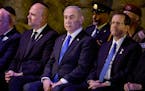 Israeli Prime Minister Benjamin Netanyahu, center, and President Isaac Herzog, right, attend a wreath-laying ceremony marking Holocaust Remembrance Da