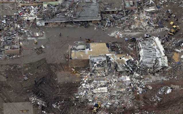 FILE - A Tuesday, May 21, 2013 file photo, an aerial view shows Plaza Towers Elementary School, which was destroyed in Monday's tornado, in Moore, Okl