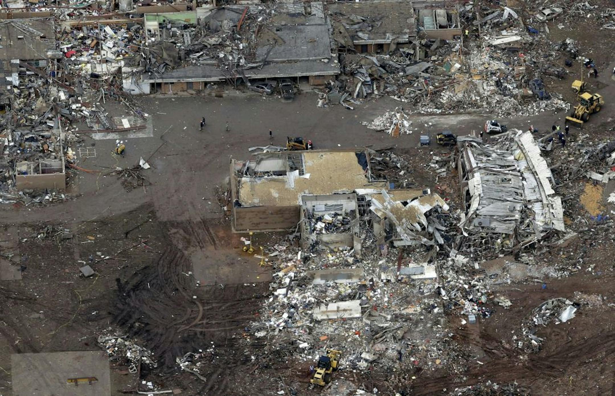 FILE - A Tuesday, May 21, 2013 file photo, an aerial view shows Plaza Towers Elementary School, which was destroyed in Monday's tornado, in Moore, Okla. Unlike several others schools in the Oklahoma City area, Plaza Towers had no �safe room� in which students and teachers could huddle. The deaths of seven students at Plaza Towers highlights the patchwork of protection that exists at schools in tornado-prone parts of the central U.S.
