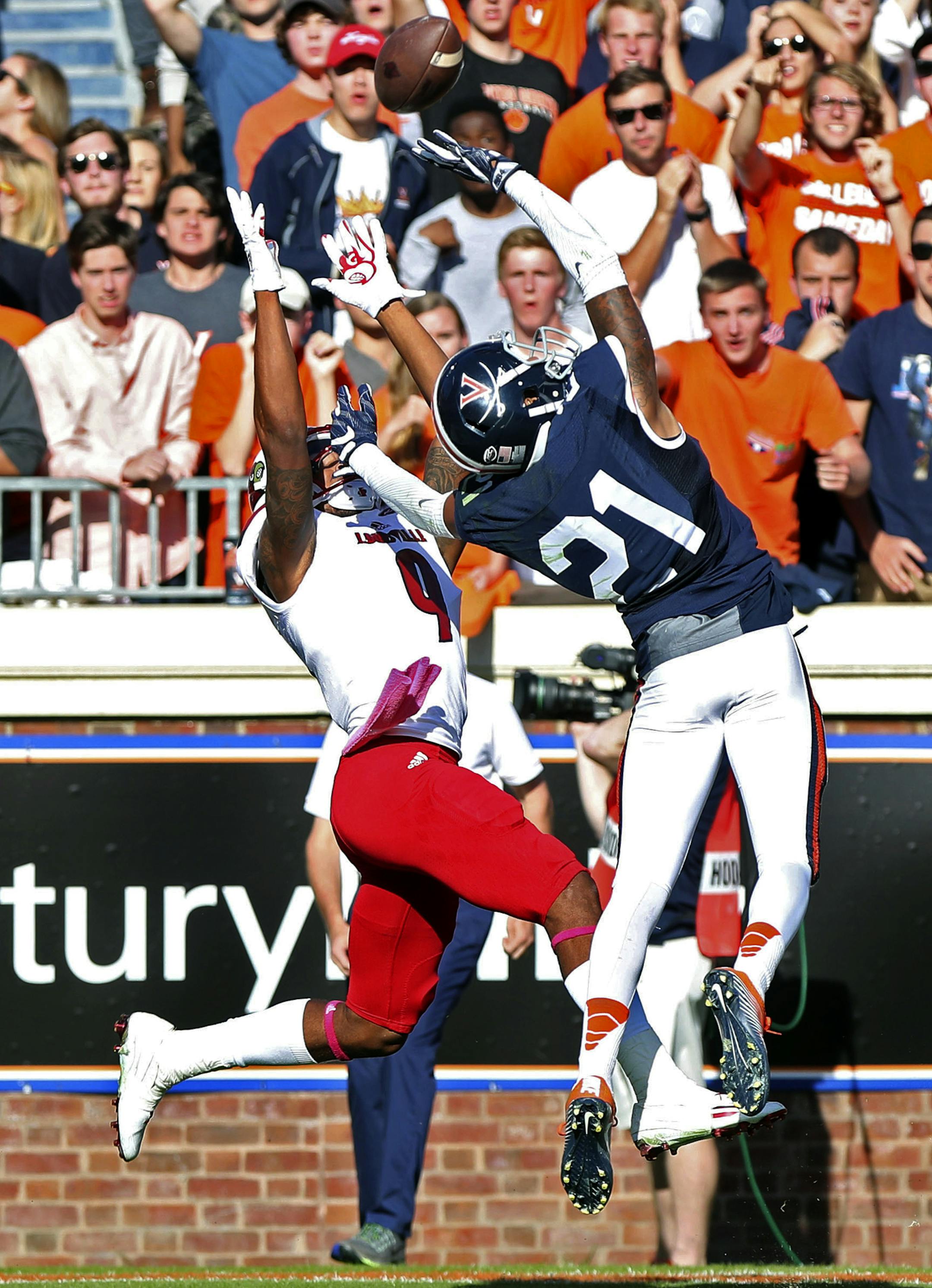 Louisville wide receiver Jaylen Smith (9) catches a touchdown pass over Virginia free safety Juan Thornhill (21) during the second half of an NCAA college football game on Saturday, Oct. 29, 2016 in Charlottesville, Va. Louisville defeated Virginia 32-25. (AP Photo/Ryan M. Kelly)