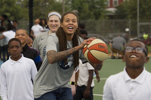 WNBA Champion Minnesota Lynx Guard Seimone Augustus makes a free throw while students watch her at Payne Elementary School in Washington, Wednesday, June 6, 2018. Payne Elementary has the highest homeless student population in the district.