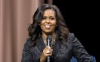 Former first lady Michelle Obama speaks to the audience during a stop on her book tour for "Becoming," in Washington on Sunday, Nov. 25, 2018.
