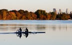 A rowing crew skims across a placid Lake Nokomis with fall colors and the Minneapolis skyline Thursday, Oct. 189, 2018, in Minneapolis, MN.] DAVID JOL