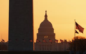 The Washington Monument and the U.S. Capitol are seen in Washington, at sunrise Wednesday, March 18, 2020. The White House has sent Congress an emerge