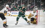 Minnesota Wild left wing Marcus Foligno (17) and Vegas Golden Knights defenseman Alex Pietrangelo (7) competed for the puck in the first period. ]