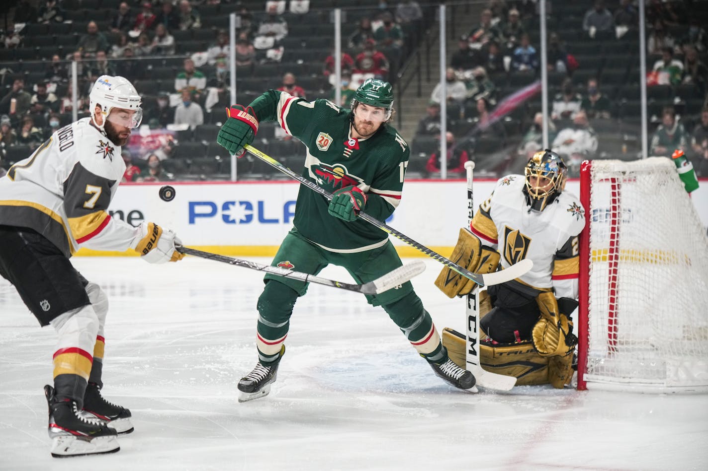 Minnesota Wild left wing Marcus Foligno (17) and Vegas Golden Knights defenseman Alex Pietrangelo (7) competed for the puck in the first period. ]