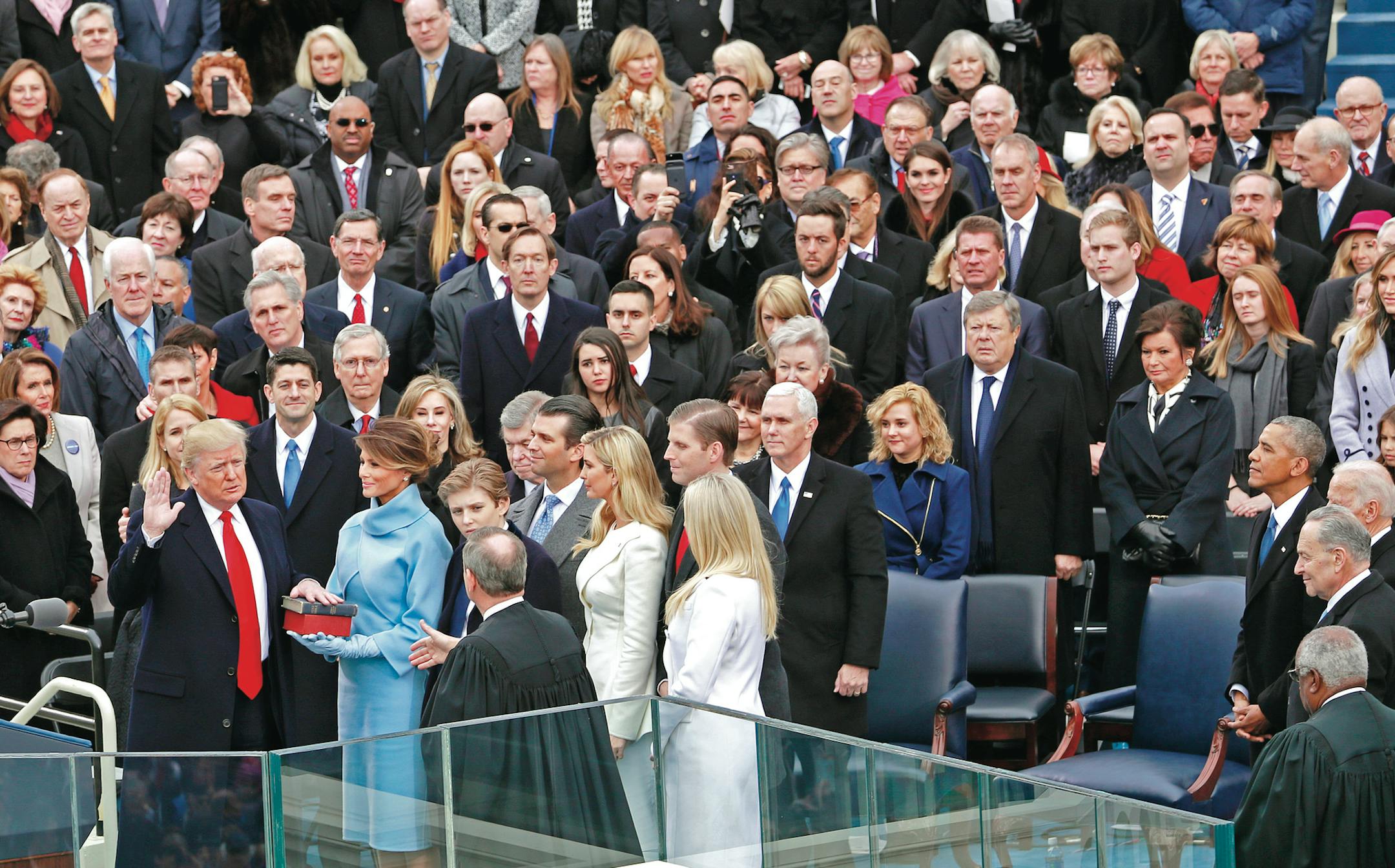 Supreme Court Chief Justice John Roberts administers the oath of office of the President of the United States to Donald Trump, as his wife, Melania Trump, holds bibles, at the U.S. Capitol in Washington, Jan. 20, 2017. (Doug Mills/The New York Times)