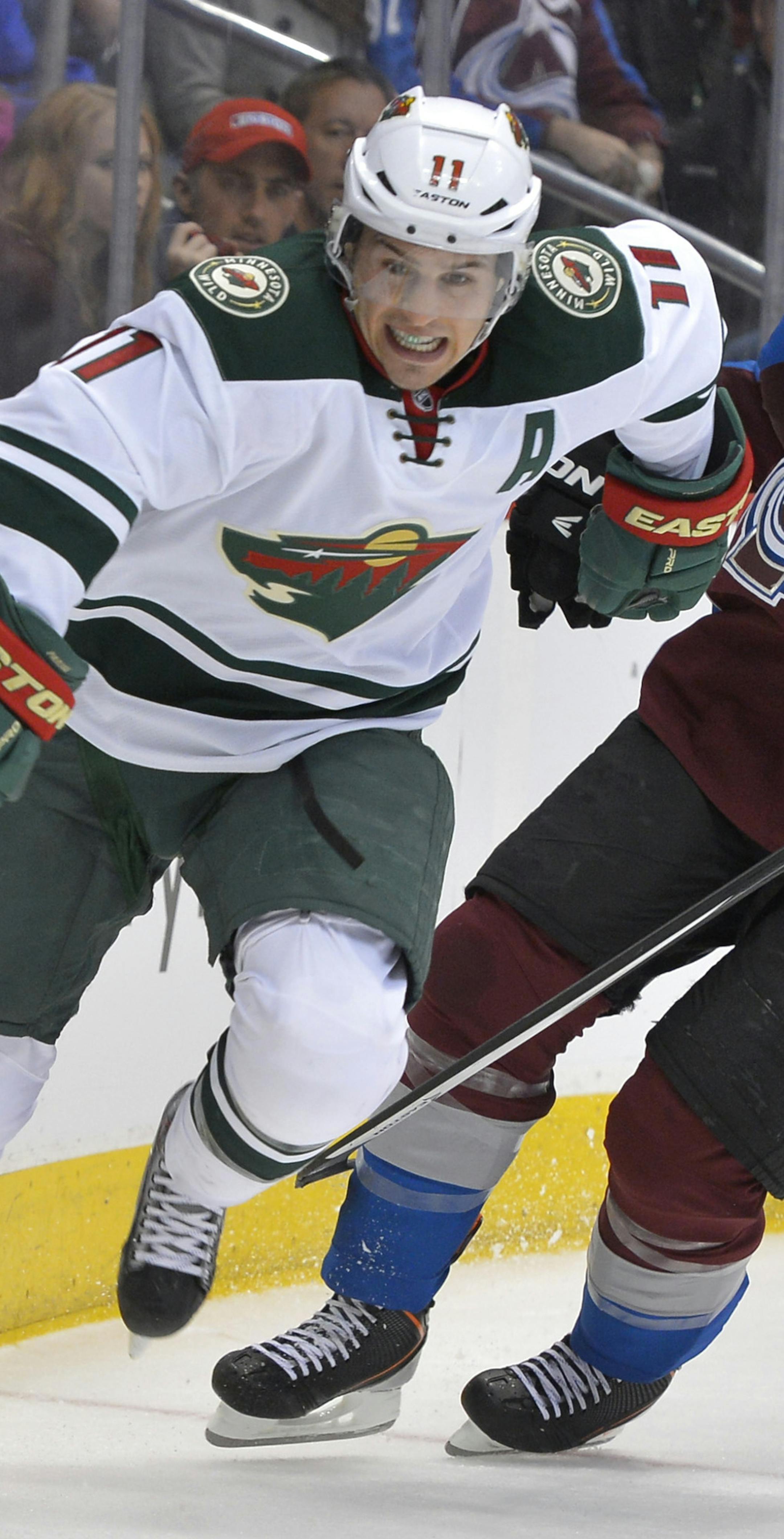 Minnesota Wild left wing Zach Parise (11) and Colorado Avalanche defenseman Erik Johnson (6) skate during the third period in Game 1 of an NHL hockey first-round playoff series on Thursday, April 17, 2014, in Denver. (AP Photo/Jack Dempsey) ORG XMIT: otk