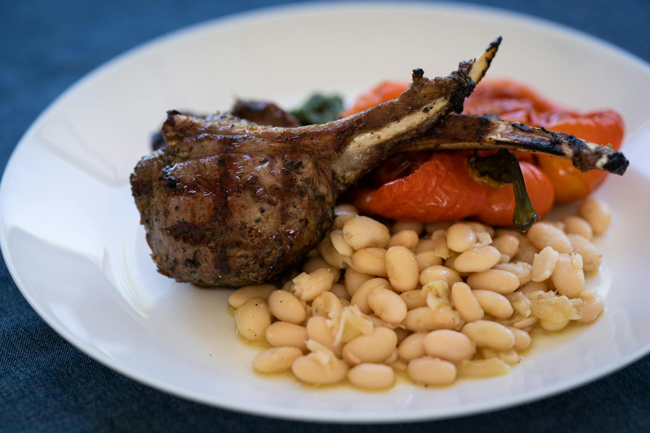 Lamb "scottaditto" rib chops, braised white beans, salad verde and roasted red peppers at Gia at the Lake.