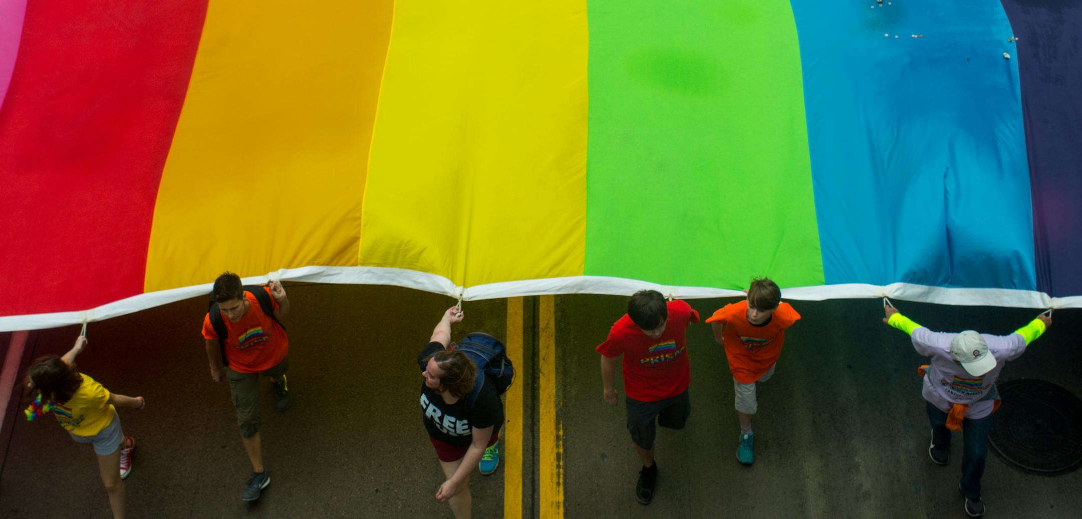 Prism Campus Alliance, a group out of Saint Paul College, marches with a gay pride flag. ] NICOLE NERI ¥ nicole.neri@startribune.com BACKGROUND INFORMATION: Sunday June 23, 2019 at the Minneapolis Pride Parade, starting at 2nd Avenue and 3rd Street and ending at Loring Park.