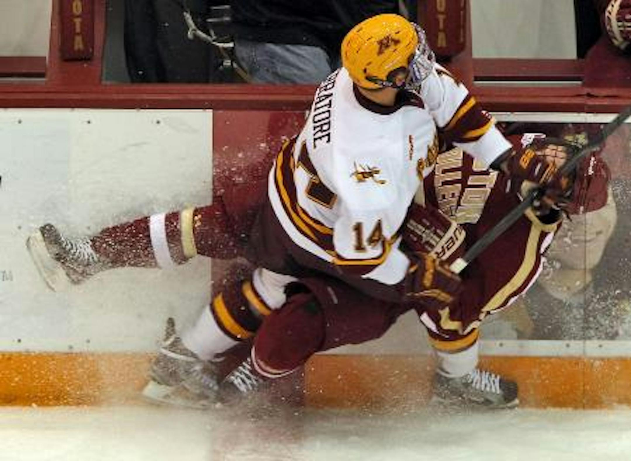 Minnesota's Tom Serratore (14) checked BC's Colin Sullivan into the boards in the first period of the Gophers' 8-1 rout. Marlin Levison / StarTribune.com