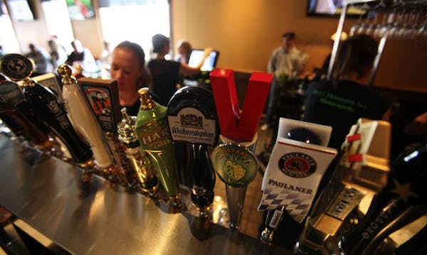 Bullfrog bartenders worked behind a row of beer taps the evening of a Twins home game.