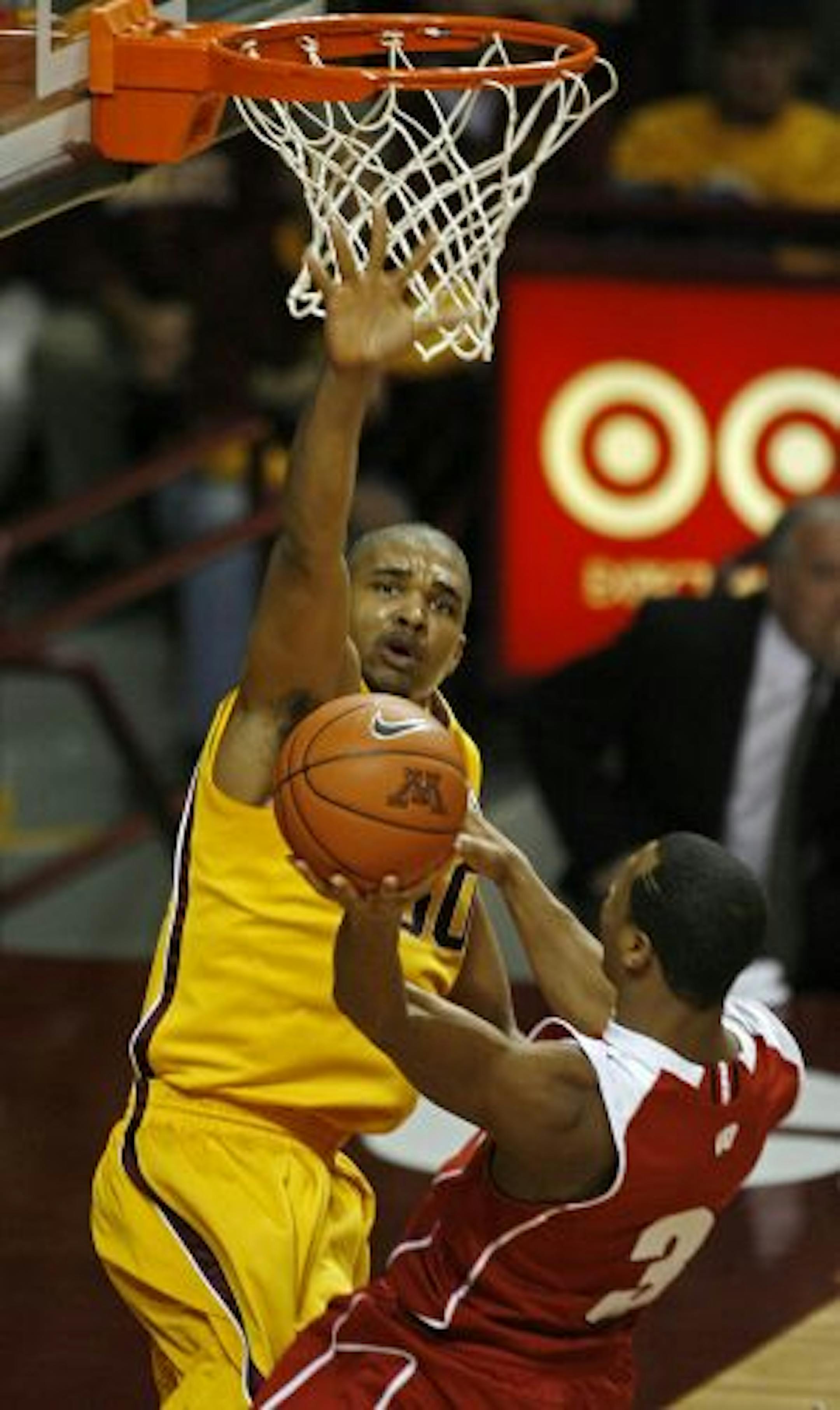 Gophers center Ralph Sampson III blocked the shot of Wisconsin's Trevon Hughes (3) in the first half of the Gophers' 68-52 victory.