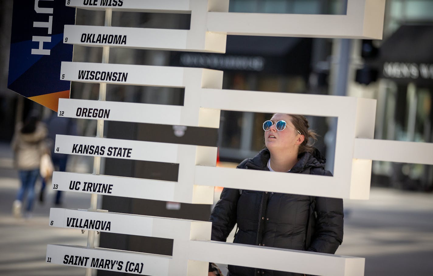 Marli Komarek searched for her favorite team, Wisconsin, on a 3D sculpture of the Final Four bracket on the Nicollet Mall just outside the IDS tower.