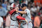 Minnesota Twins catcher Ryan Jeffers, left, and relief pitcher Jhoan Duran (59) celebrate after a baseball game against the Houston Astros Monday, May