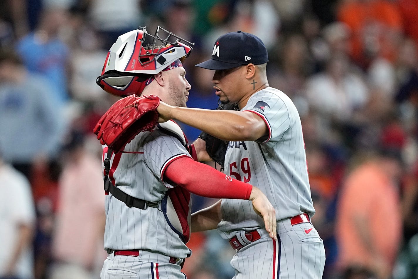 Minnesota Twins catcher Ryan Jeffers, left, and relief pitcher Jhoan Duran (59) celebrate after a baseball game against the Houston Astros Monday, May 29, 2023, in Houston. The Twins won 7-5 in 10 innings. (AP Photo/David J. Phillip)