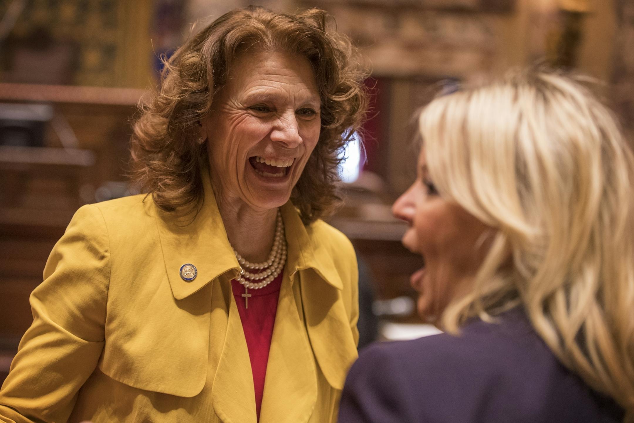 Sen. Carrie Ruud, R-Breezy Point, left, and Sen. Karin Housley, R-St. Marys Point, talk before the session in the Minnesota Senate chambers.